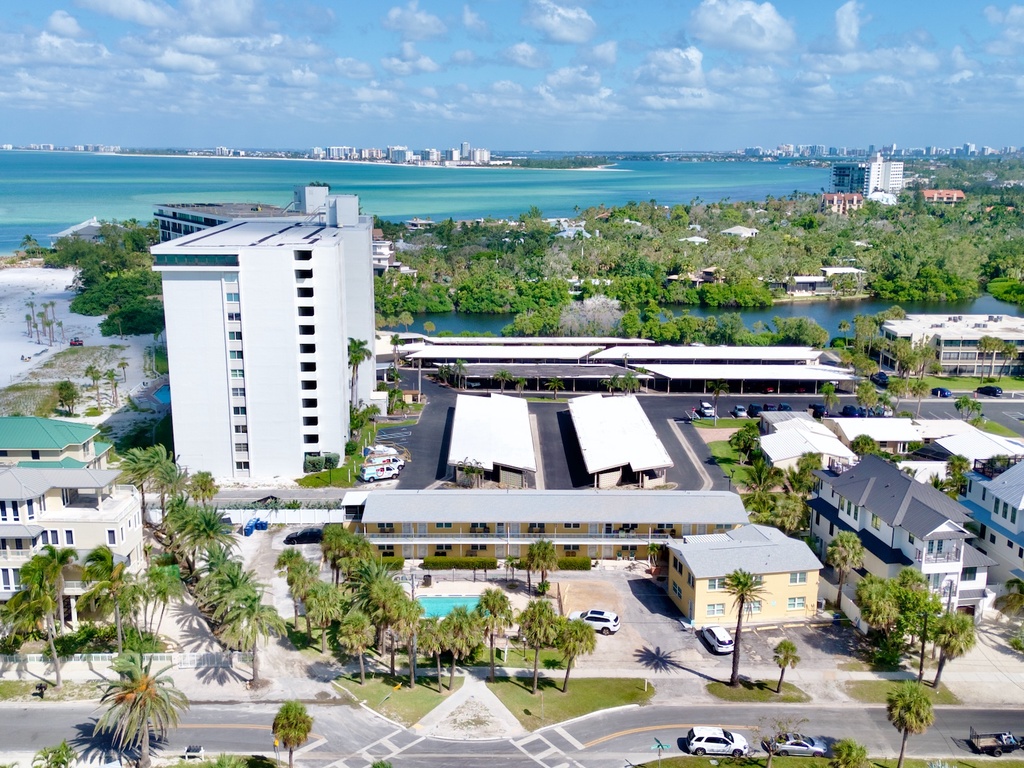 Stunning beachfront resort complex with turquoise waters and pristine white sand beaches stretching along the coast.