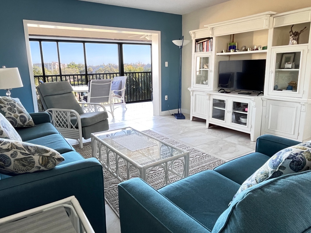 Relax in this bright living room where coastal colors meet comfort. Sink into plush seating while enjoying mountain views from your private balcony.