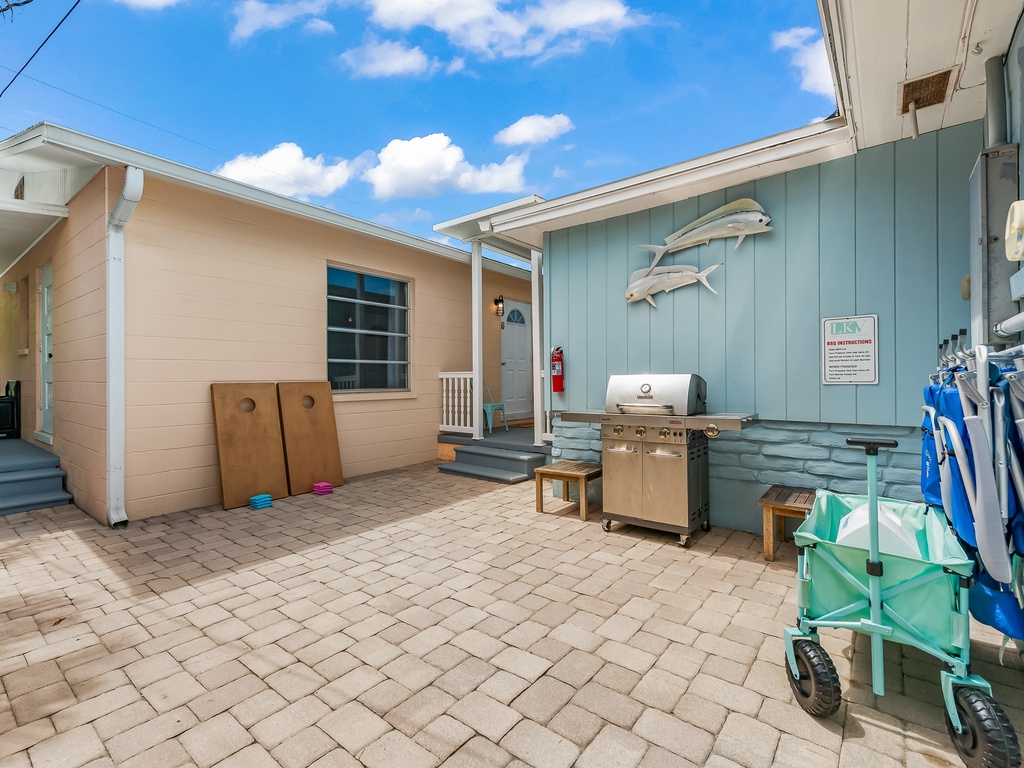 BBQ grill, beach chairs and two cornhole games