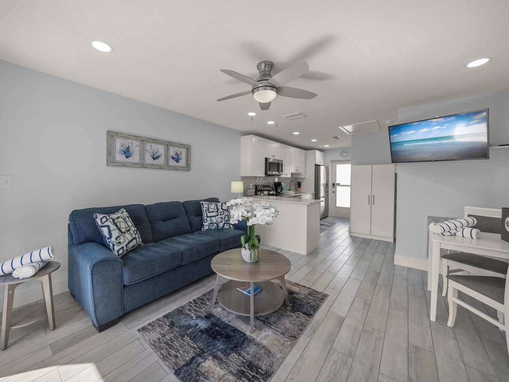 Relax in this bright, modern space where coastal blues meet crisp whites. Your open-plan living flows seamlessly into the full kitchen.
