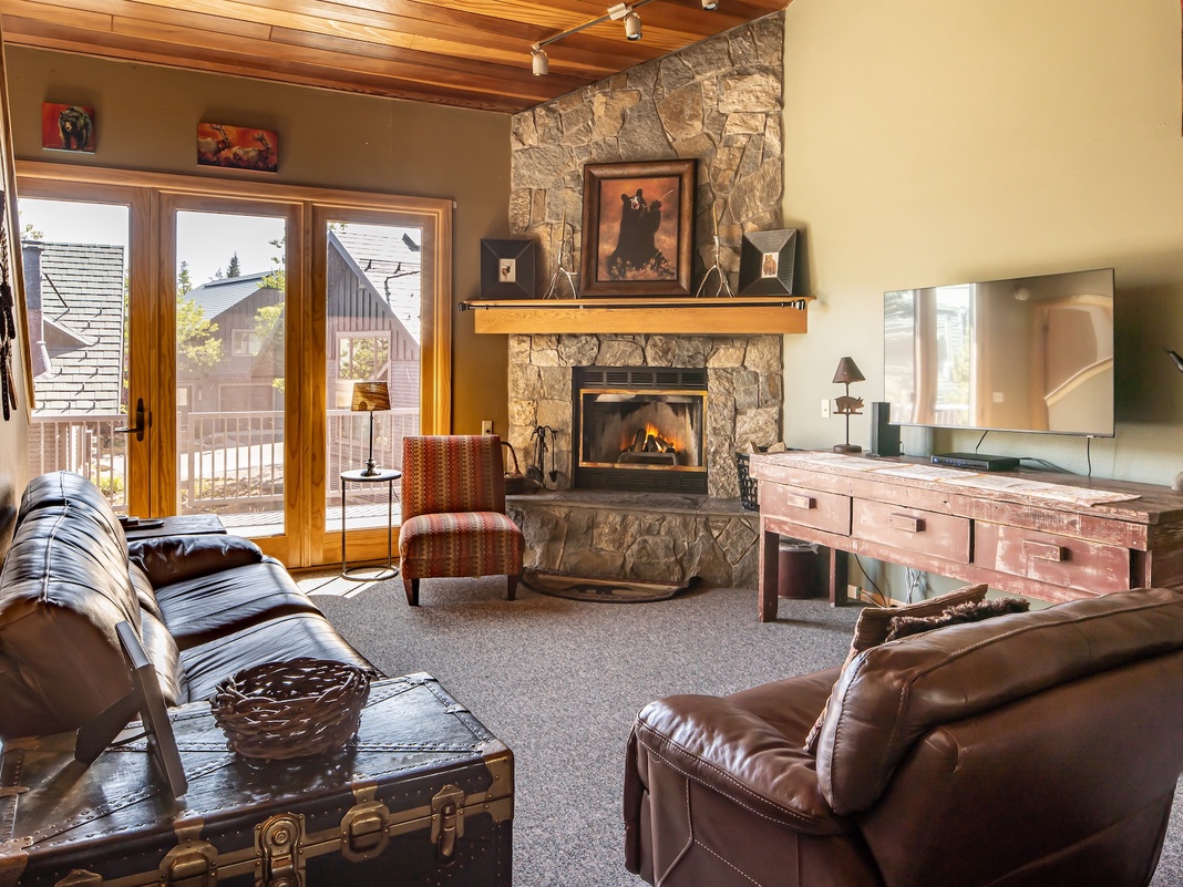 Unwind in your cozy living room, where a stone fireplace and vaulted wood ceiling create rustic mountain charm. Gather by the fire or step onto your private balcony to soak in the surroundings.
