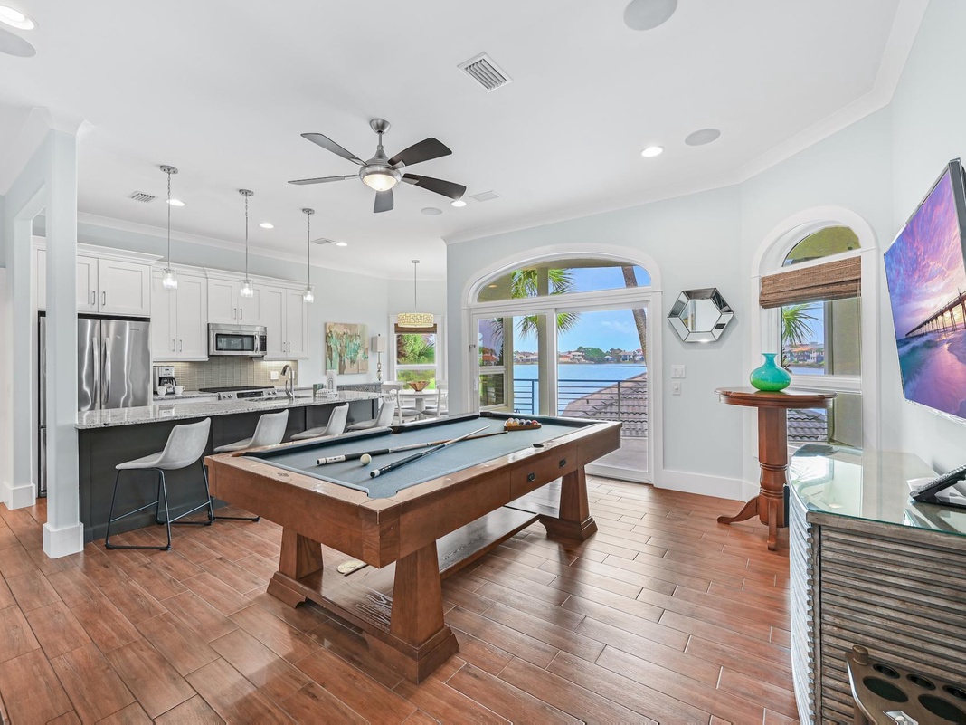 Challenge friends to pool while enjoying stunning water views through grand arched windows in your game room.