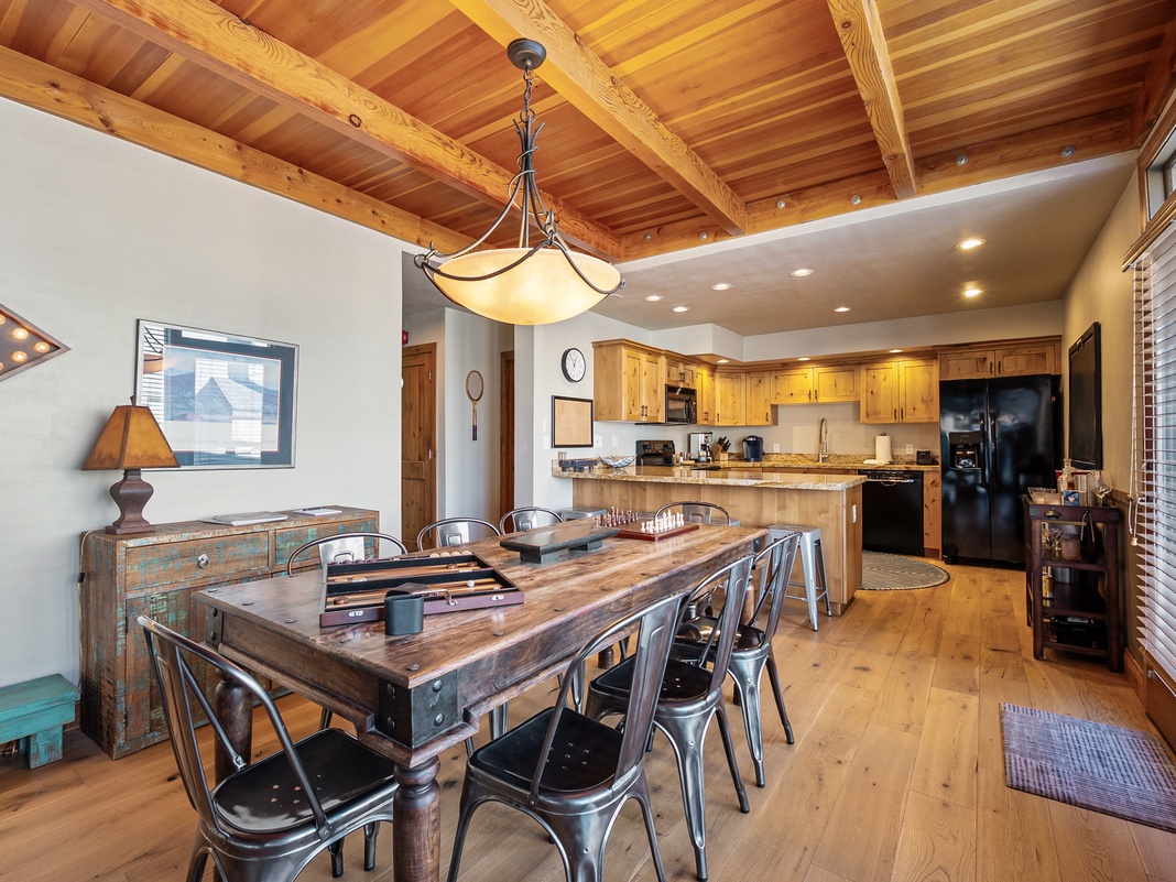 Gather around this stunning wood beam dining space where warm lighting and rustic charm create perfect moments for your group meals together.