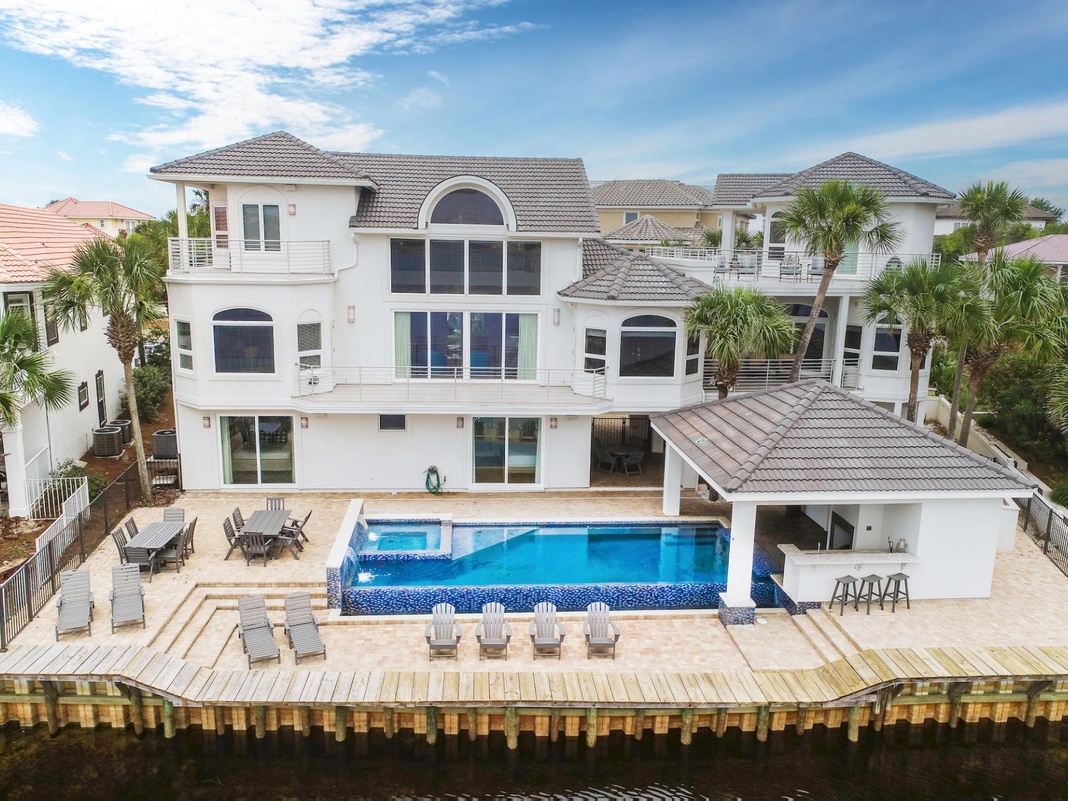 Stunning waterfront luxury home with private pool and expansive outdoor entertaining space in prestigious neighborhood setting.