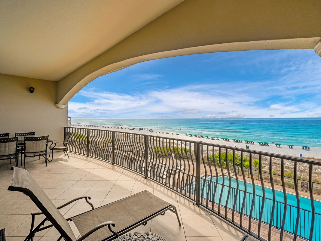 Stunning beachfront balcony where turquoise waves meet white sand, with your private poolside perch for sunsets and morning coffee overlooking paradise.