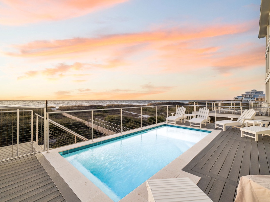 Stunning sunset over the ocean creates a breathtaking backdrop for your private pool deck experience.