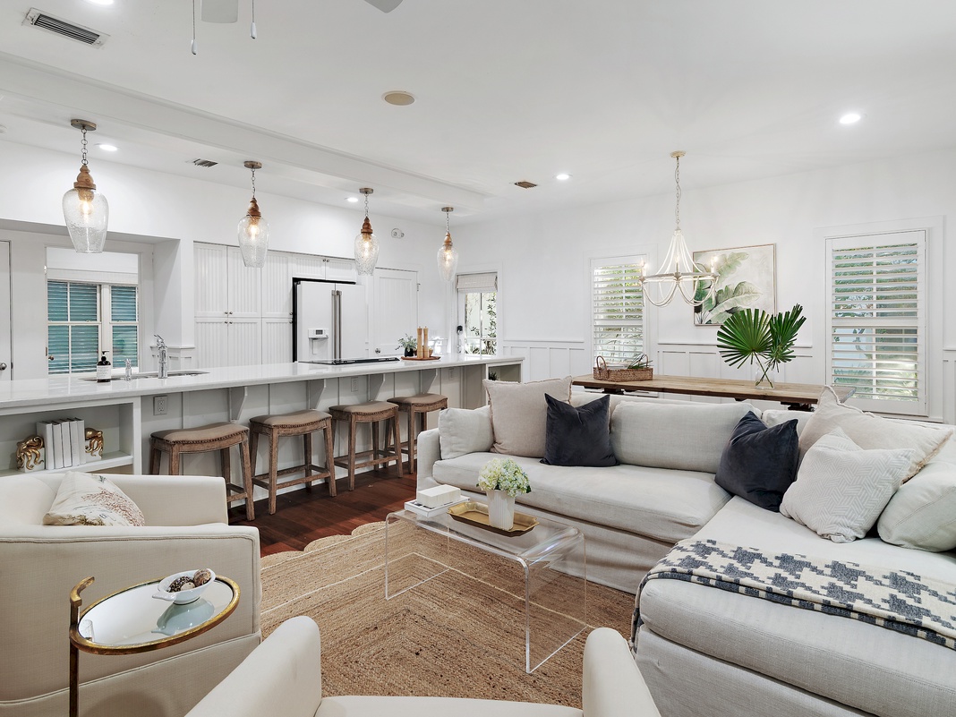 Settle into this elegant open-concept living space where coastal charm meets modern comfort, perfect for your group gatherings.