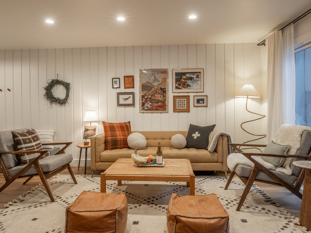 Sink into this thoughtfully styled living space where warm wood tones meet cozy textiles, creating your perfect retreat for relaxation.