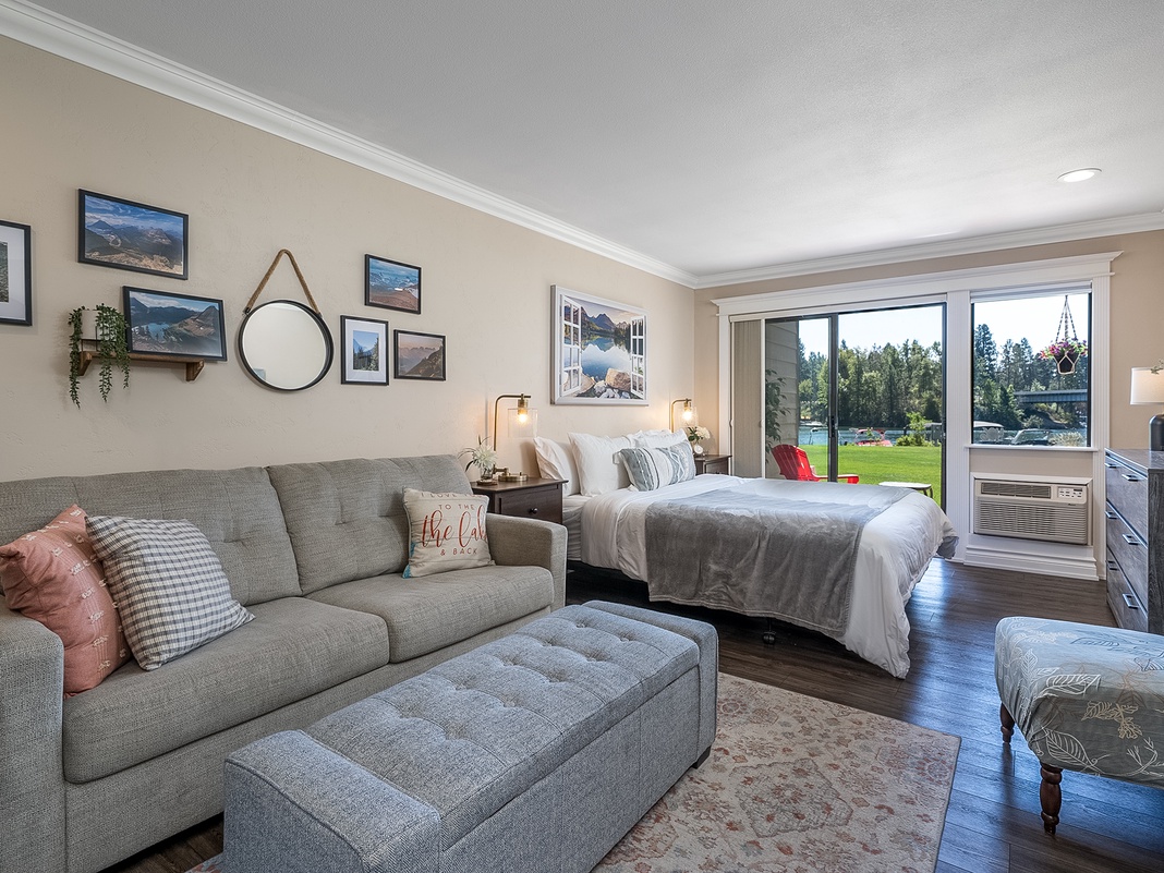 Unwind in your bright studio with plush seating, a cozy bed, and large windows framing peaceful green views. It's the perfect blend of style and comfort for your getaway.
