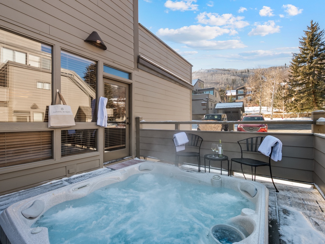 Soak in your private hot tub while mountain views create the perfect alpine backdrop for relaxation.