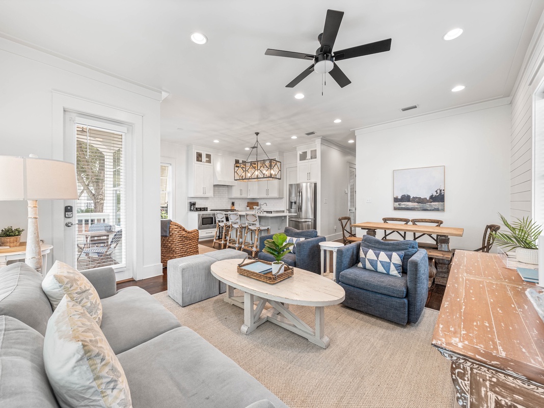 Relax in your bright, open-concept living space with comfortable seating, modern kitchen, and coastal charm throughout.
