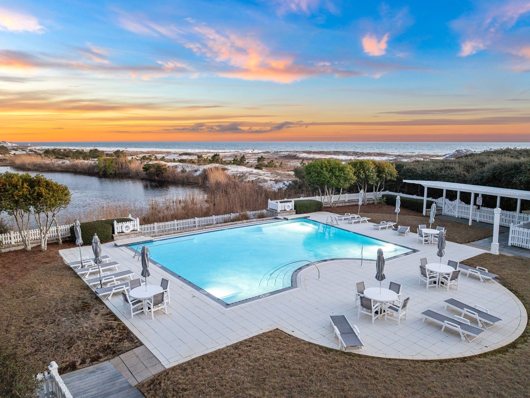 Stunning oceanfront pool area overlooking natural lagoons and beach, perfect for watching breathtaking sunsets paint the sky in golden hues.