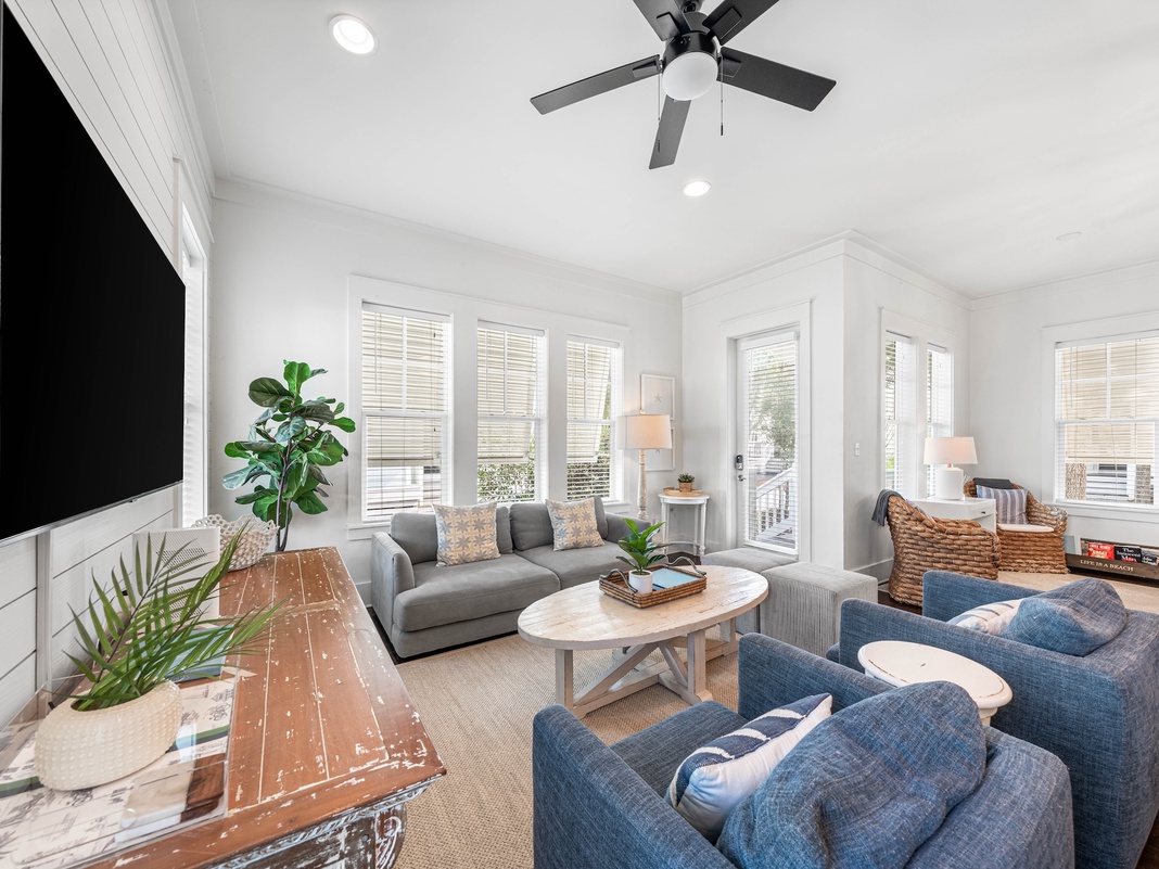 Unwind in your bright, airy living space with cozy seating and coastal charm that invites relaxation.