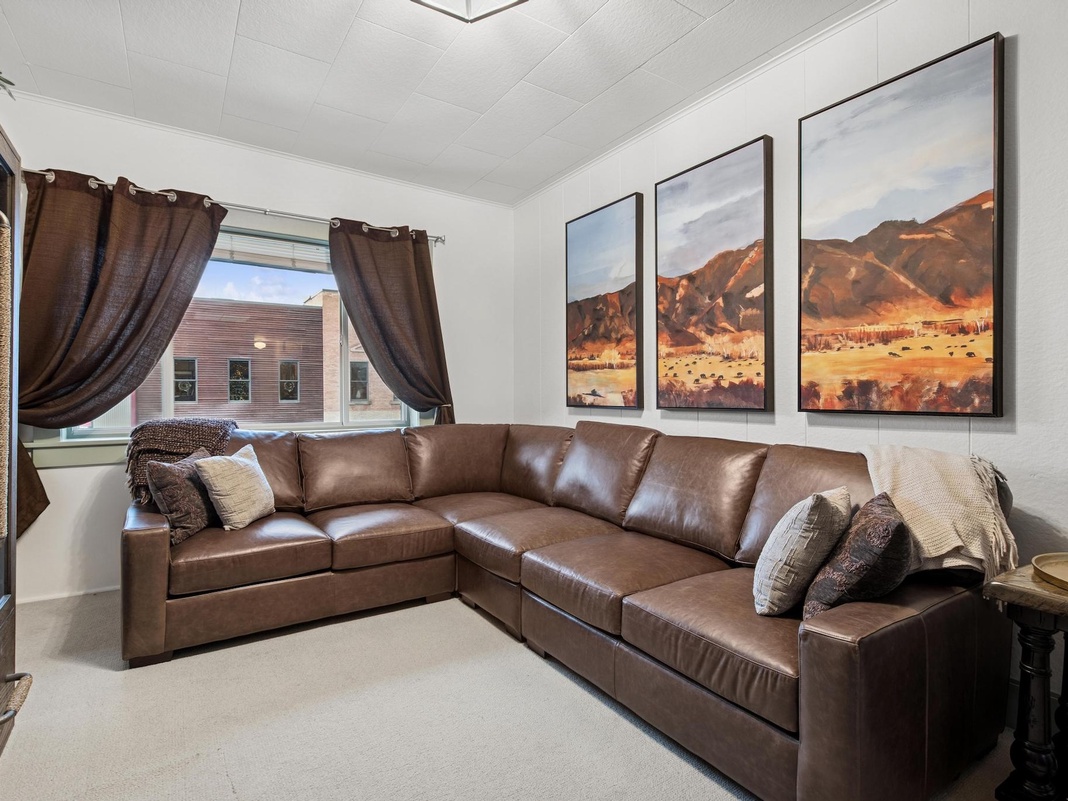 Sink into this luxurious leather sectional while beautiful desert landscape art sets a serene mood for your perfect getaway.