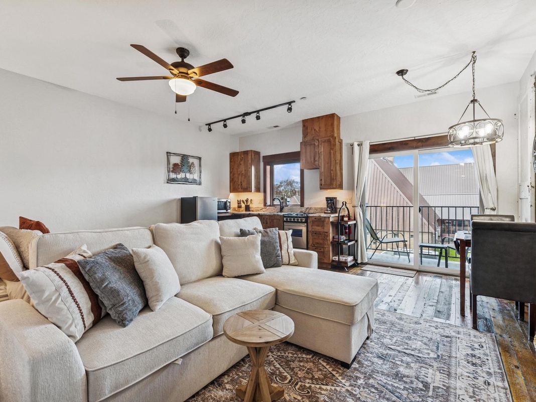 Sink into your plush sectional sofa and enjoy the open-concept living with modern kitchen, perfect for cozy evenings together.