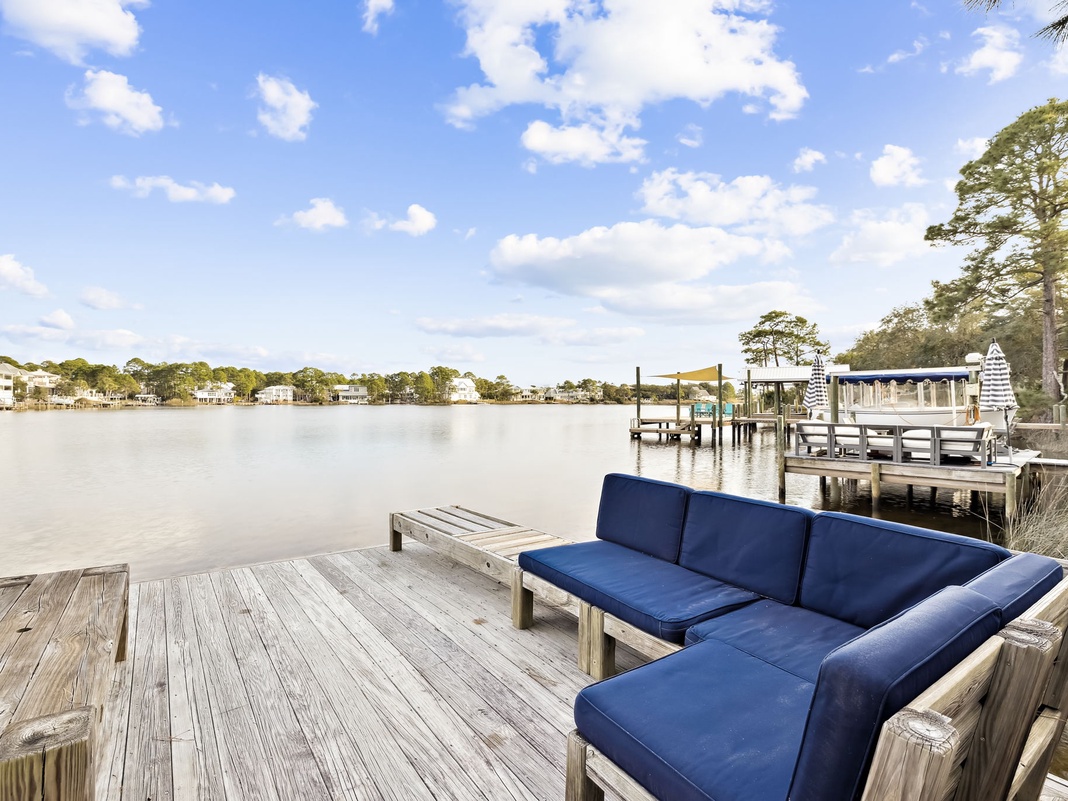 Serene waterfront setting with comfortable seating overlooking calm waters and charming coastal homes.