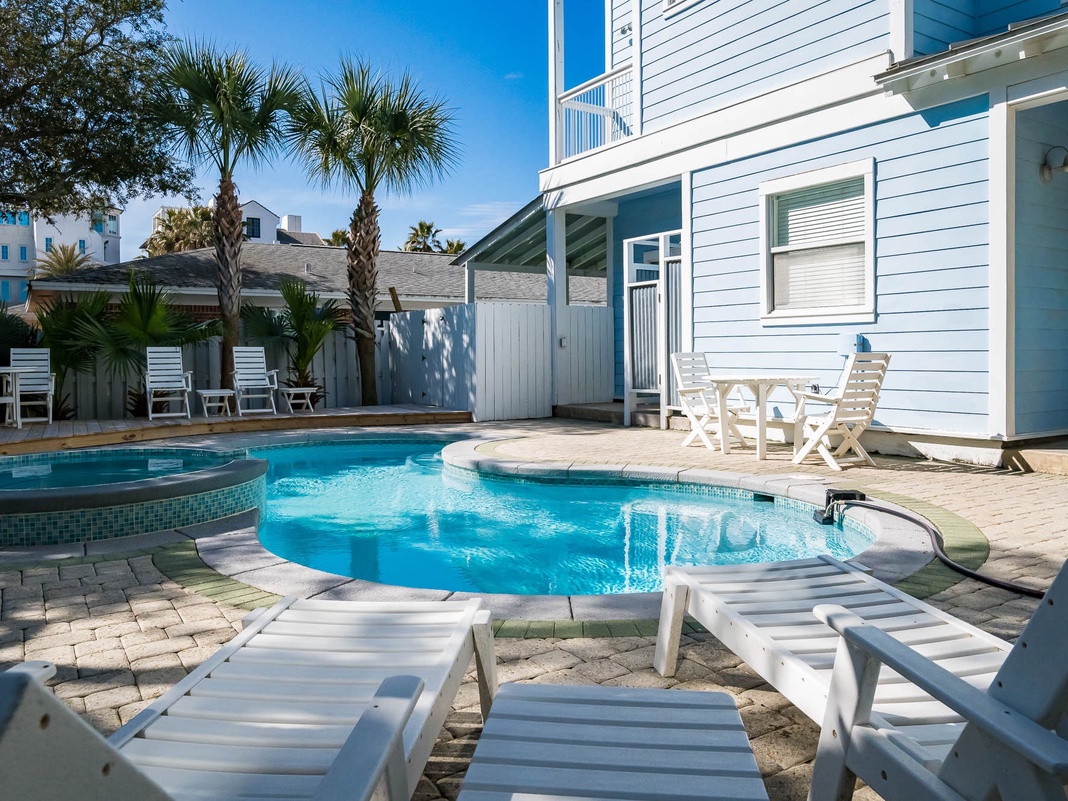 Your private pool paradise awaits with sparkling blue waters, comfortable loungers for soaking up the sunshine, and palm trees swaying overhead.