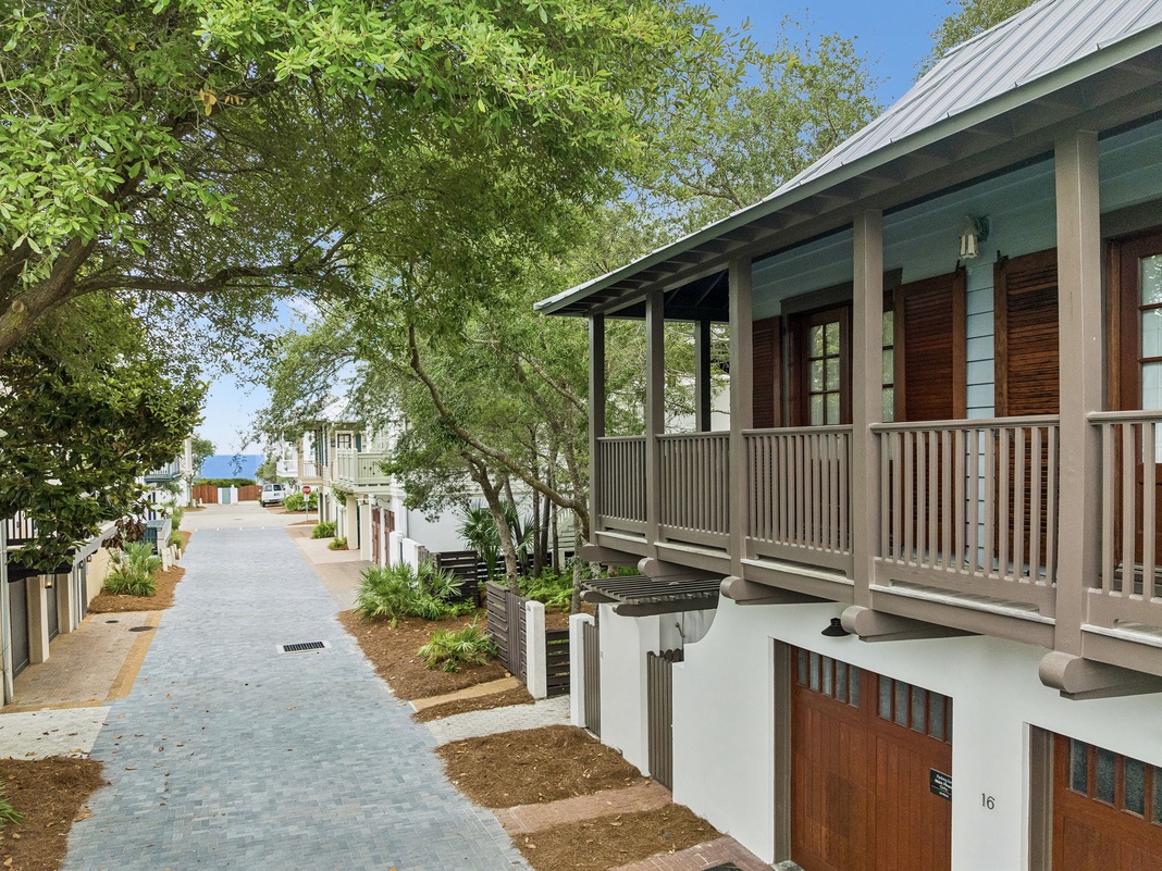 The property sits along a peaceful, tree-lined street in a charming coastal neighborhood, offering easy access to nearby beaches and local attractions.