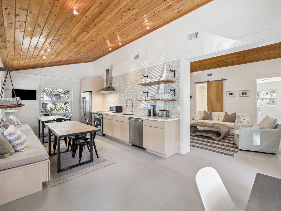 Relax in this stunning open-concept space where modern design meets rustic charm, featuring warm wood ceilings and sleek finishes.