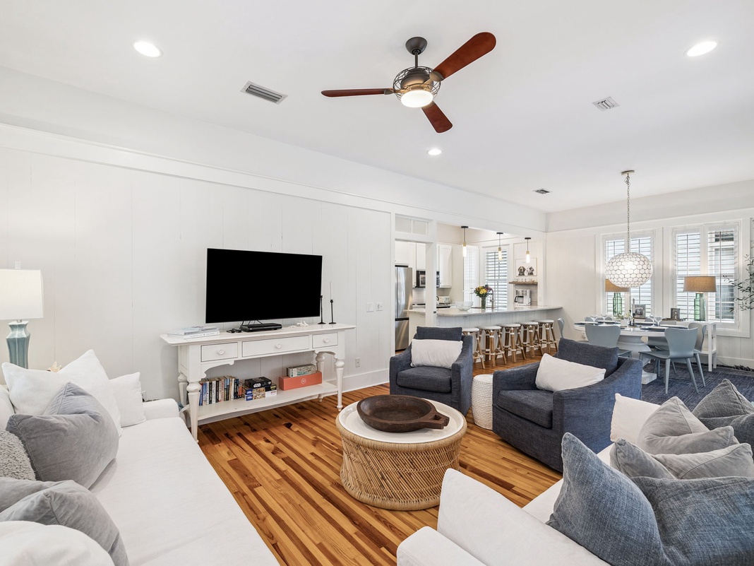 Unwind in your spacious living area where modern comfort meets coastal elegance, complete with plush seating and open-concept design.