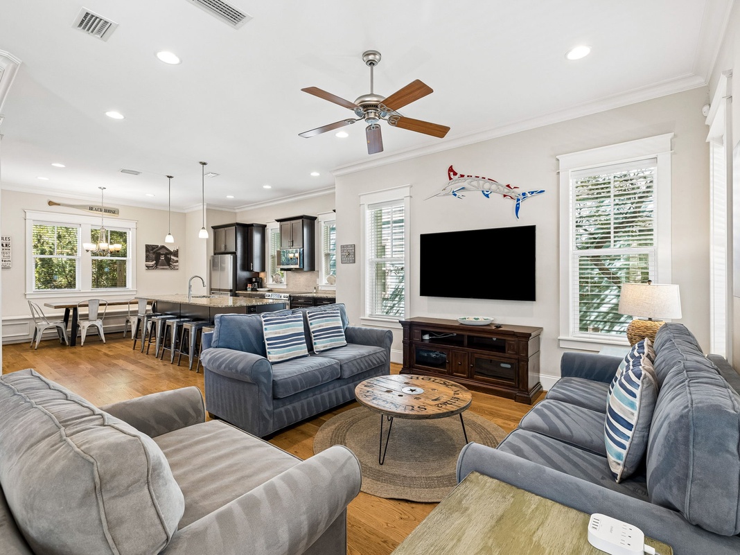 Unwind in this bright, open space where cozy seating and coastal-inspired touches invite you to relax after a day of exploring. Your retreat flows seamlessly into a fully equipped kitchen and dining area, perfect for gathering together.