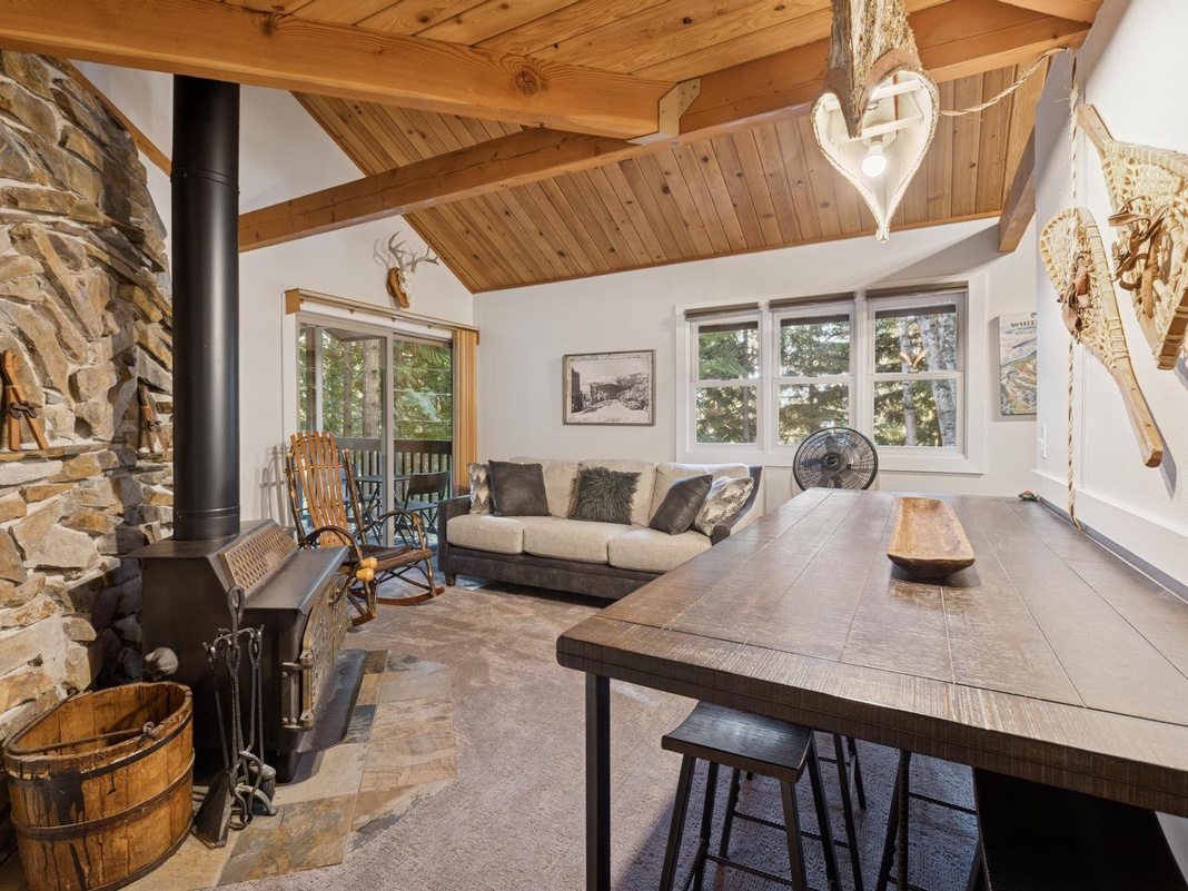 Unwind in your rustic-chic living space where exposed beams meet modern comfort, perfect for cozy evenings by the fireplace.