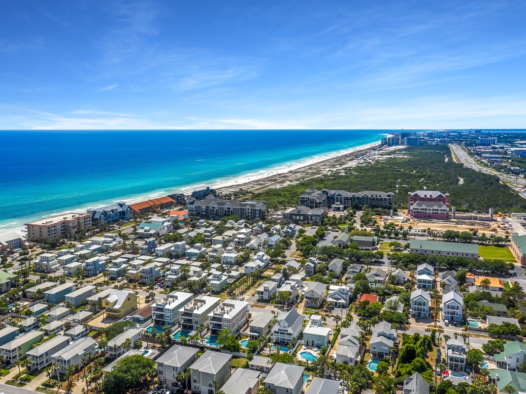 Stunning aerial view of this beachfront coastal community, showcasing pristine white sand beaches and turquoise waters just steps from your door.