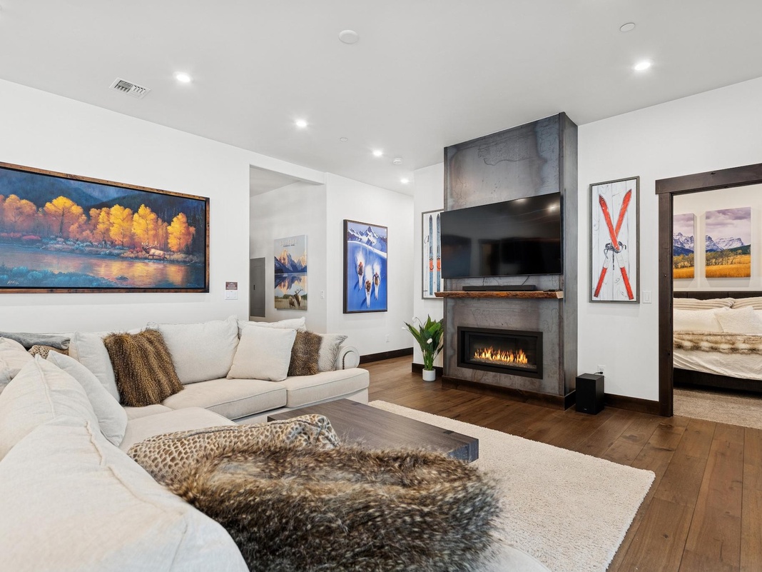 Unwind in this elegant living room where cozy seating surrounds a warm fireplace, perfect for your evening relaxation.