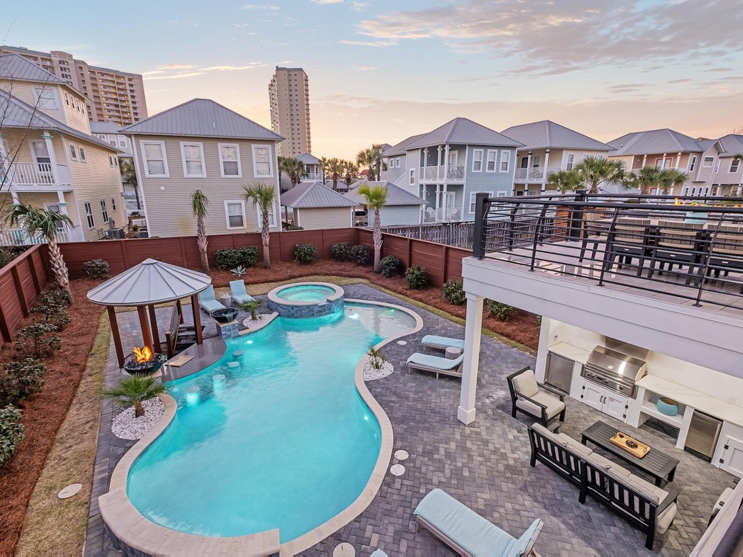 Luxurious heated swimming pool with a swim-up bar and a sitting spa.