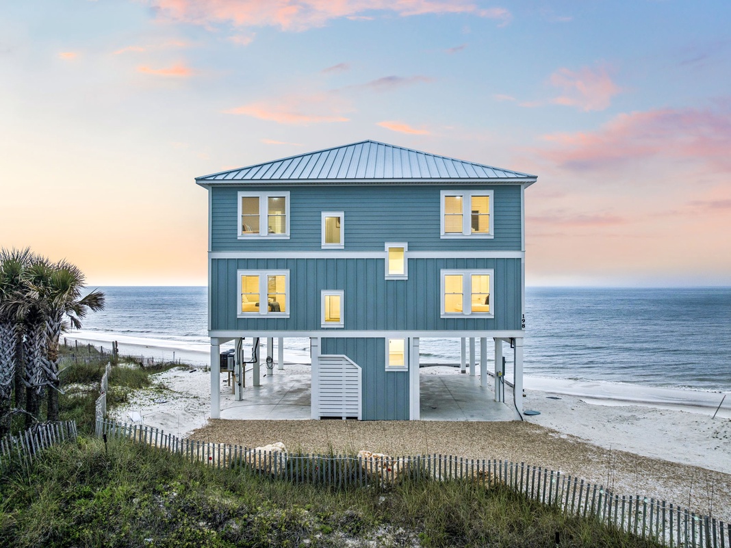 Stunning beachfront property with direct ocean access and breathtaking coastal views. This elevated blue beach house sits right on the shoreline, offering an idyllic seaside retreat.