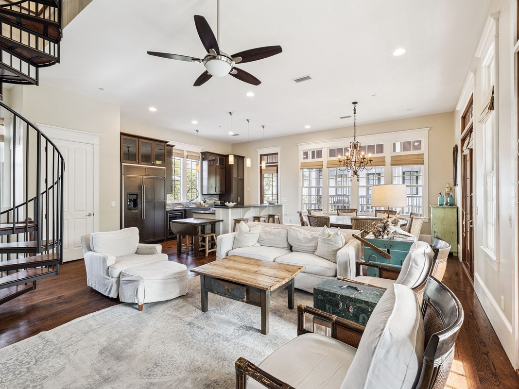 Relax in your spacious open-concept living space with soaring ceilings, elegant spiral staircase, and plush seating perfect for unwinding after exploring.