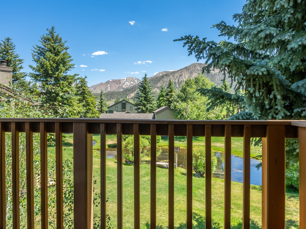 This balcony frames breathtaking mountain views, surrounded by evergreens and a peaceful creek winding through the property. Perfect for your morning coffee or evening relaxation.