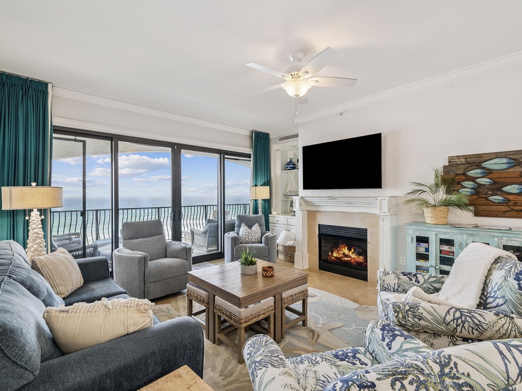 Unwind in this cozy oceanfront living room where your ceiling fan keeps you comfortable while you enjoy the sea breeze and fireplace ambiance.