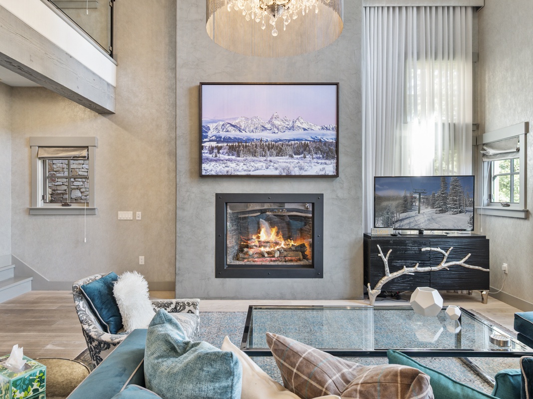 Cozy up by your crackling fireplace while enjoying mountain views on the large TV in this stylish living room.