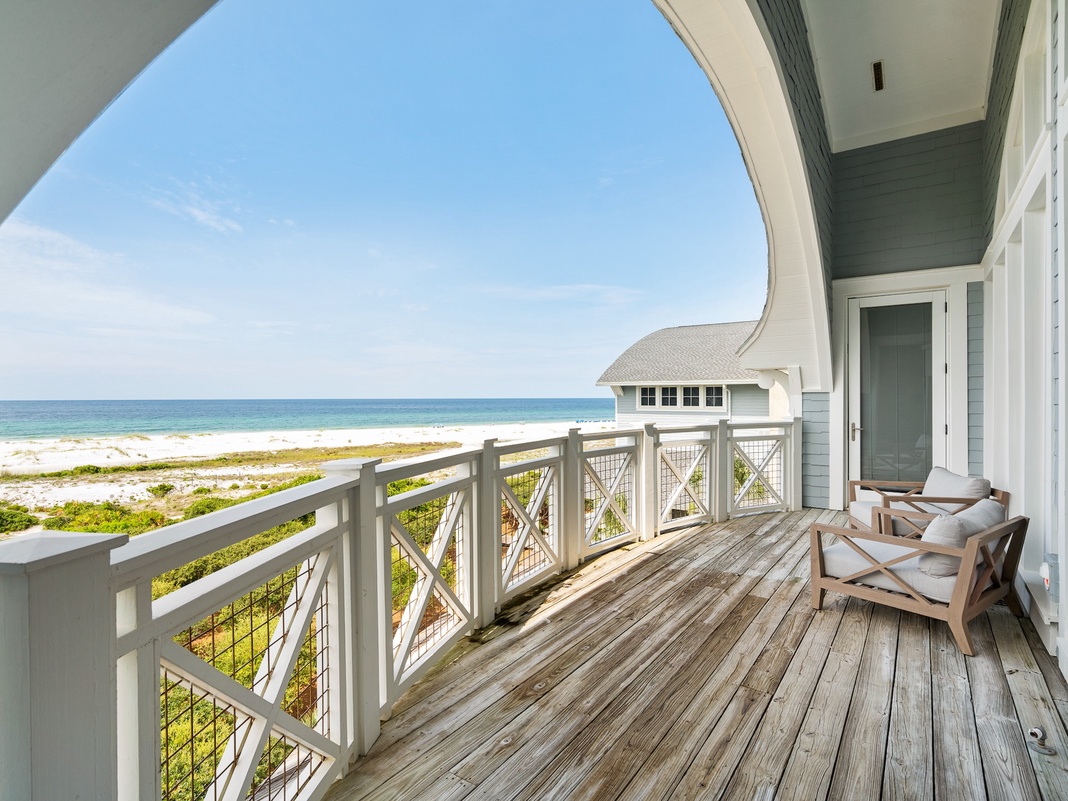 Step onto your private oceanfront balcony and soak in stunning beach views while relaxing in comfortable seating.