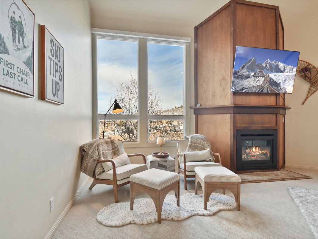 Sink into cozy chairs by your crackling fireplace while mountain views fill the windows—perfect for après-ski relaxation.