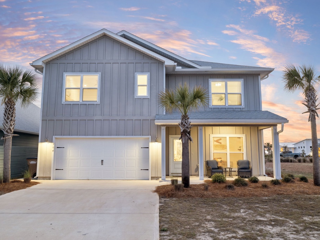 Modern coastal home with beautiful architecture and palm trees, capturing the essence of beachside living.