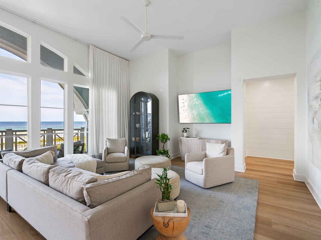 Sink into plush seating while ocean waves dance outside your floor-to-ceiling windows in this bright, airy living space.