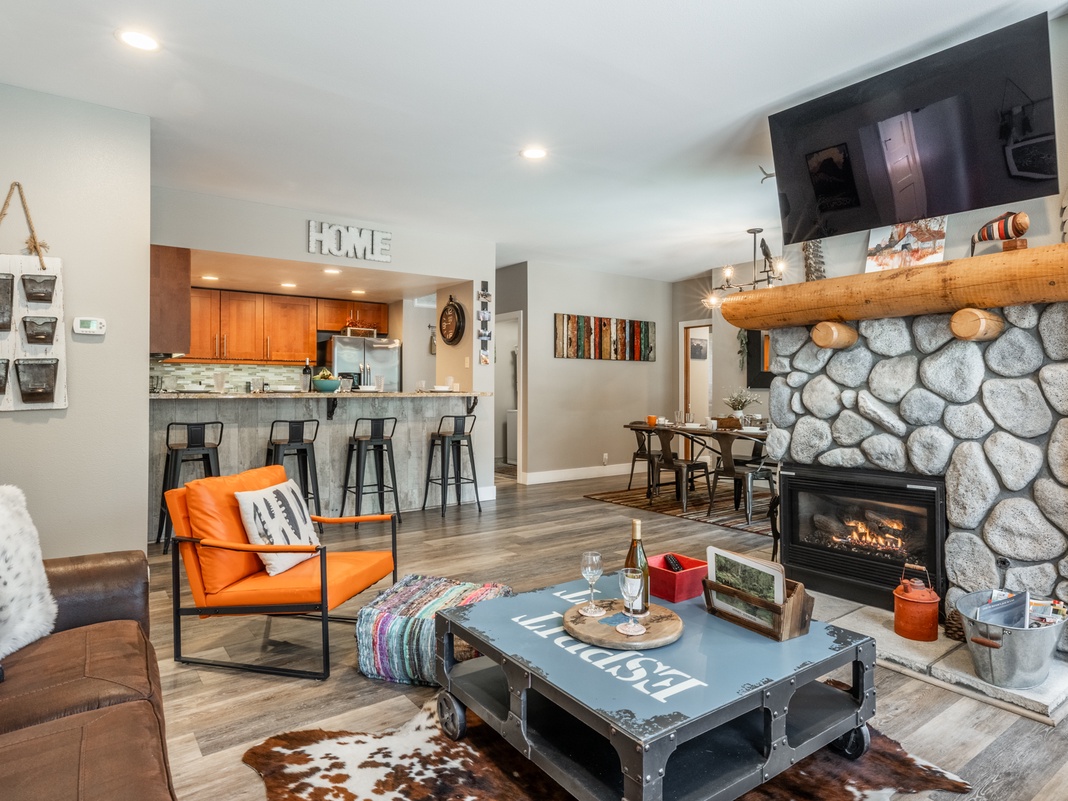 Cozy up by the stone fireplace in your stylish open-concept retreat, where modern comfort meets rustic charm.