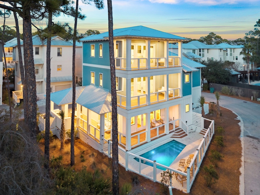 Stunning coastal vacation home with private pool nestled among towering pines in an exclusive beachside community.