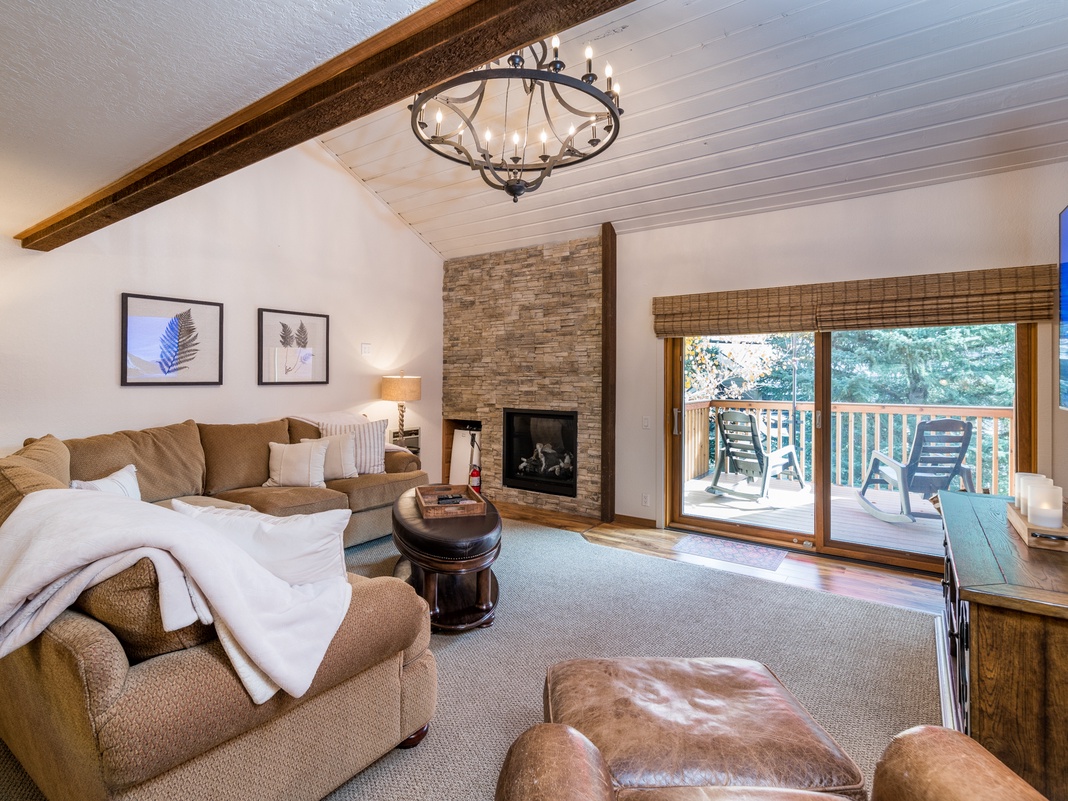Settle into the spacious living room, where a cozy fireplace, vaulted ceilings, and your own private balcony invite you to unwind in mountain style.