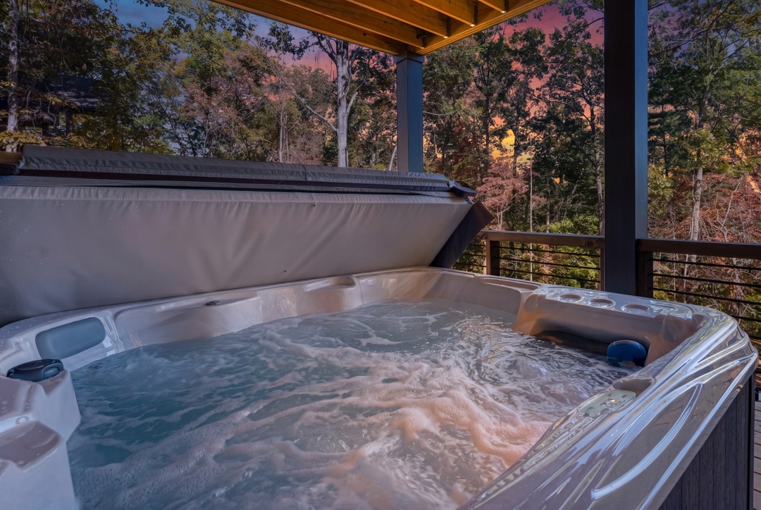Soak in your private hot tub as the sky transforms into a canvas of pink and orange hues through the trees.