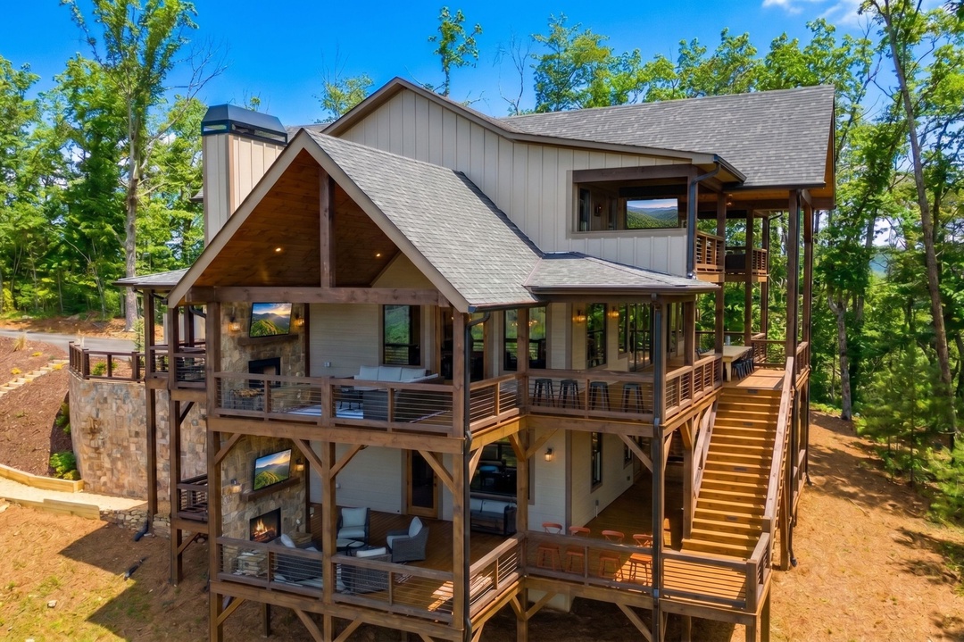 Stunning mountain retreat with expansive decks and floor-to-ceiling windows nestled among the trees, offering the perfect blend of modern comfort and natural beauty.