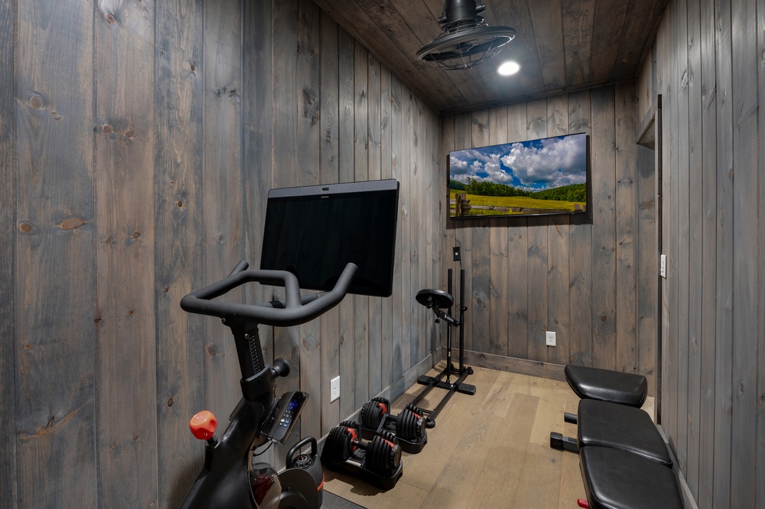 Your private fitness space features modern equipment and rustic wood accents, creating an inspiring retreat for your workouts. Stay motivated while staying connected with entertainment at your fingertips.