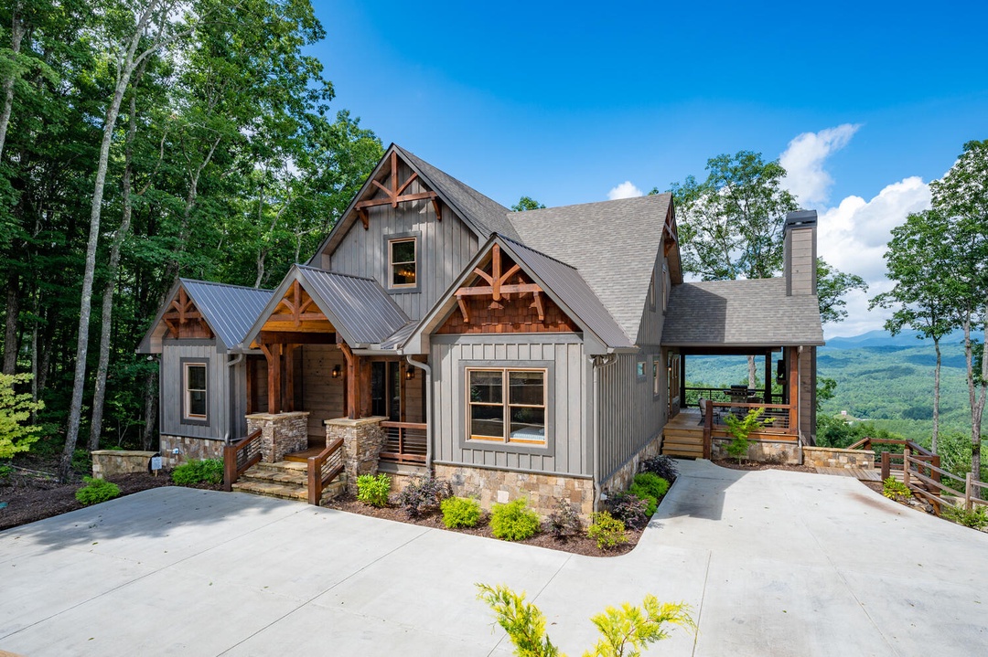 All Decked Out- Front view of the cabin with mountain views in the background