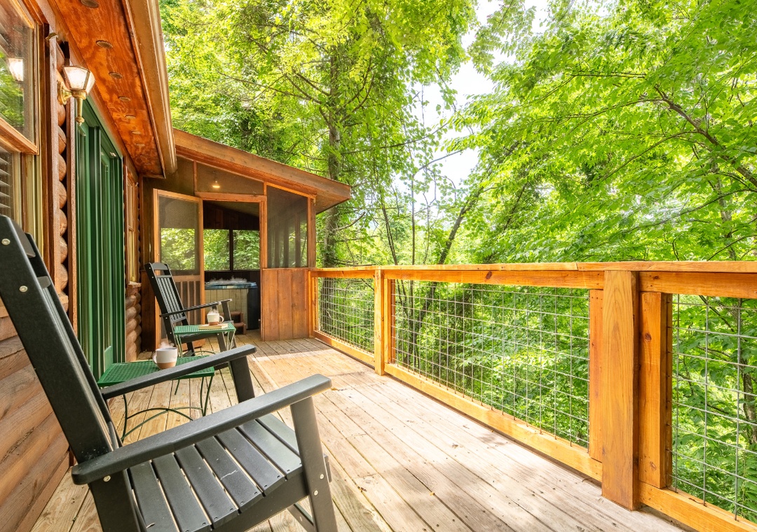 Step onto your private deck and settle into an Adirondack chair surrounded by lush forest canopy—your peaceful retreat awaits above the trees.