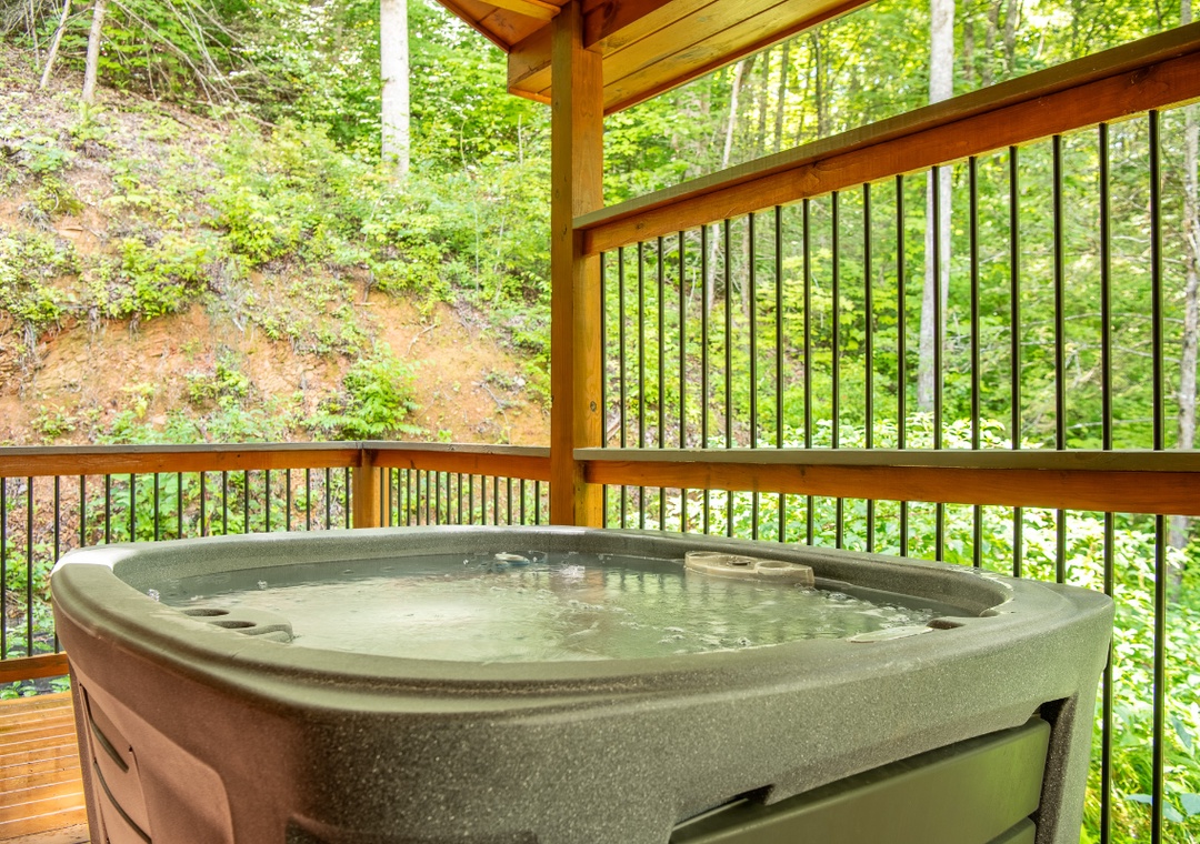 Your private hot tub awaits on this covered deck, where you can soak surrounded by lush forest and the peaceful sounds of nature. Let the warm water melt away your stress while birdsong and rustling leaves complete the scene.