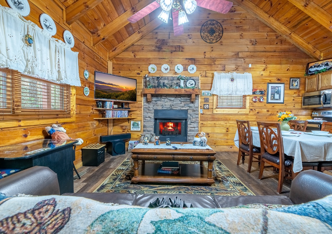 Cozy up by your crackling stone fireplace in this charming log cabin living room, complete with rustic charm and modern comforts.