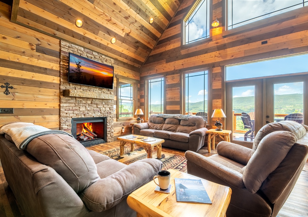 Sink into plush seating by the crackling fireplace and let your gaze drift through soaring windows to the mountain views beyond. This warm, inviting space is your retreat after a day of adventure.
