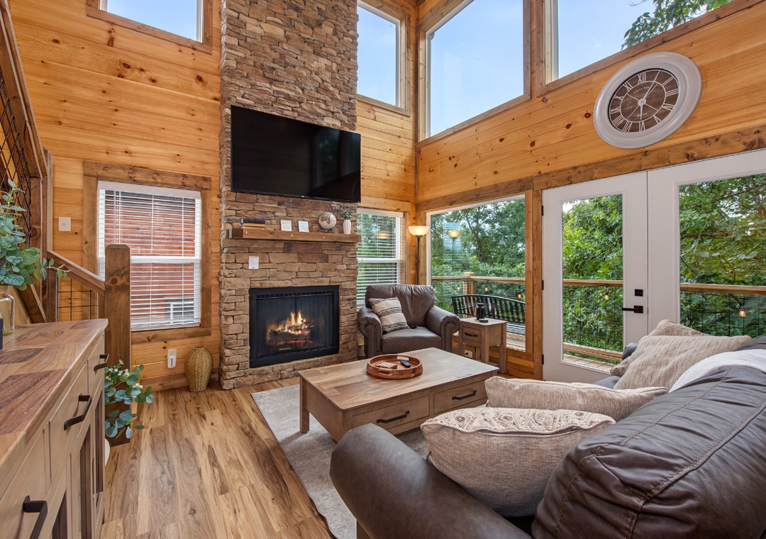 Curl up by your stone fireplace with natural light pouring through soaring windows. The cozy living room blends rustic wood beams and plush seating—perfect for unwinding after a day of adventure.